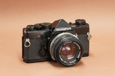 Olympus OM-1 black 35mm SLR film camera with Olympus Zuiko 50mm f/1.8 lens